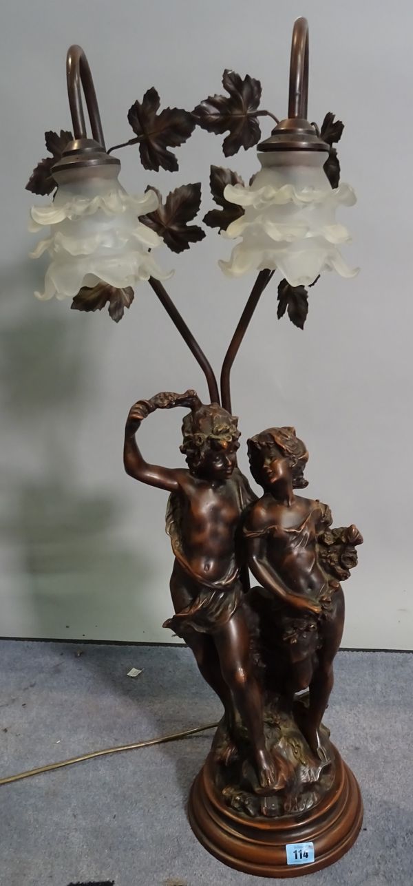 A 20th century faux bronze two branch figural table lamp with frosted floral glass shades, 82cm high.  D1