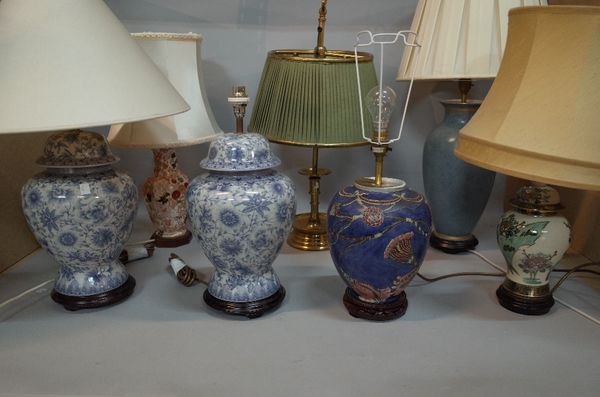 A group of seven 20th century table lamps, including; a pair of blue and white baluster vase lamps, two modern Asian lamps and three others, (7).  C3