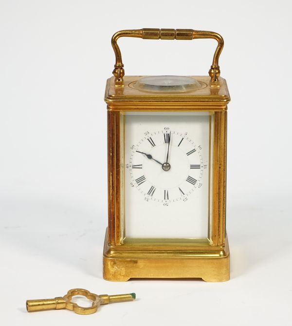 A French brass carriage clock, late 19th century, with visible escapement, plain enamel dial and twin train movement, 13cm high, (key).