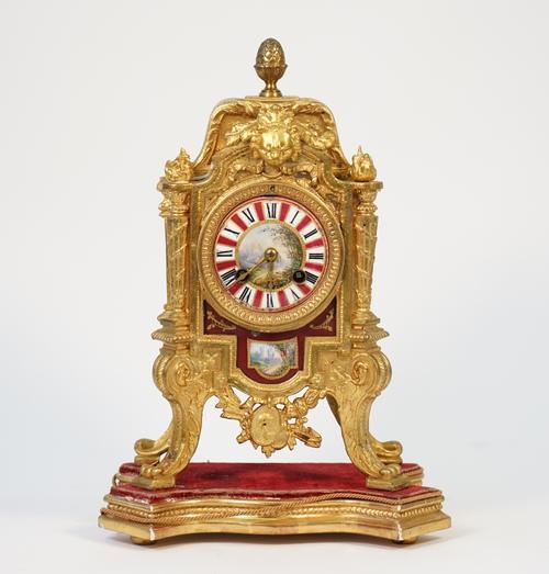 A French Louis XVI style gilt metal and porcelain mounted mantel clock, early 20th century, with two train movement, countwheel and hammer striking a