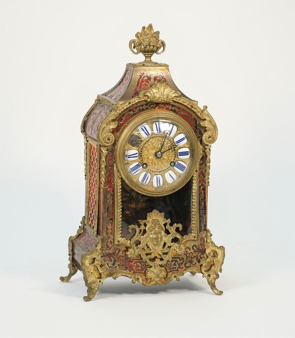 A french Boulle work mantel clock, late 19th century, with foliate finial, enamel numerals, glazed pendulum aperture and a two train movement, 35cm hi