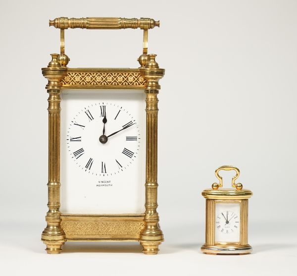 A gilt brass cased carriage clock detailed 'Vincent Weymouth' with foliate pierced frieze and single train movement, 12cm high and a miniature quartz