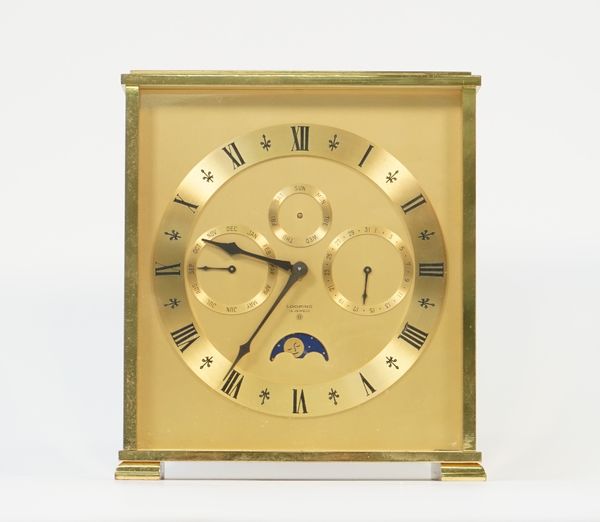 A Swiss brass "Looping" mantel clock, eight day with three subsidiary dials and moon phase aperture in a rectangular case, 18cm high.