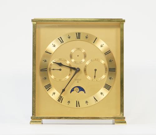 A Swiss brass "Looping" mantel clock, eight day with three subsidiary dials and moon phase aperture in a rectangular case, 18cm high.