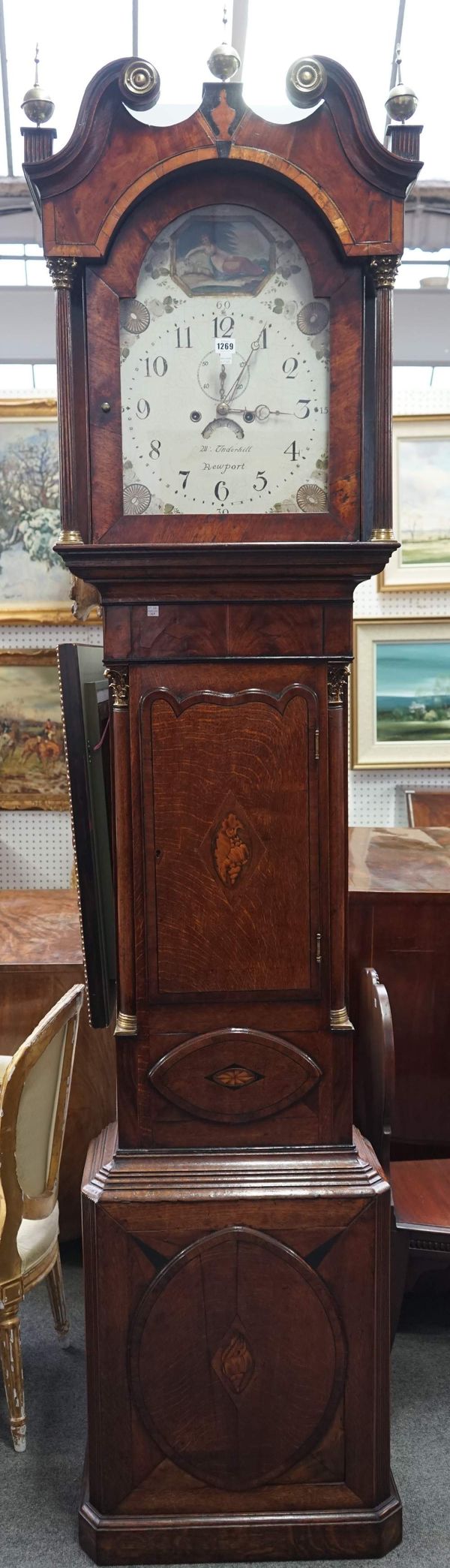 Underhill Newport, an oak and crossbanded mahogany longcase clock, the painted dial plate with subsidiary alarm and date aperture, over a waisted case