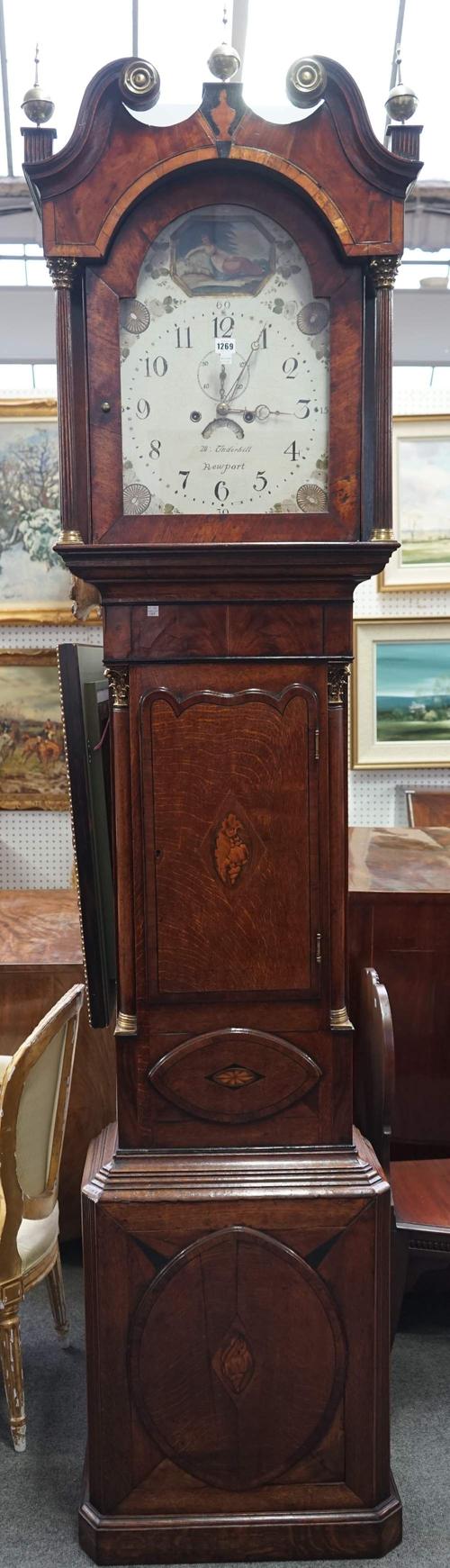 Underhill Newport, an oak and crossbanded mahogany longcase clock, the painted dial plate with subsidiary alarm and date aperture, over a waisted case