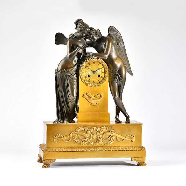 An Empire ormolu and bronze mantel clock of Cupid and PsycheThe two figures leaning towards each other over the arched case, on a rectangular base wit