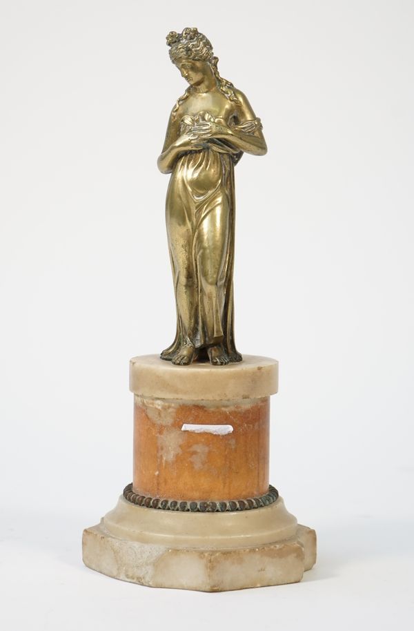 An early 19th century gilt bronze figure of a classical lady, mounted on a shaped marble socle, 27.5cm high overall.