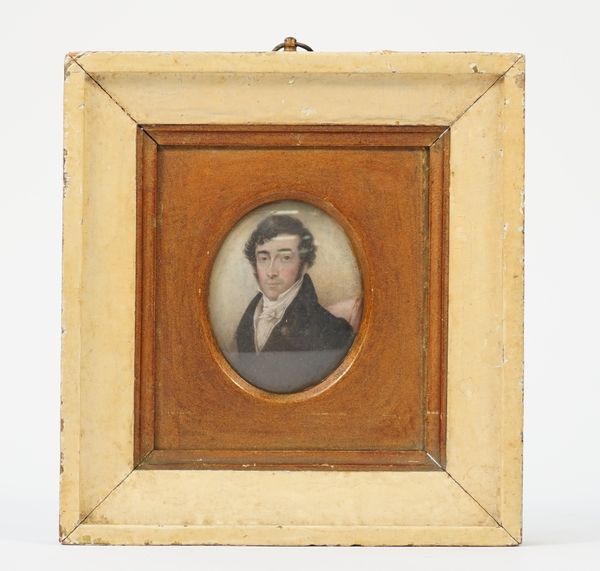 A miniature on ivory, 19th century depicting a gentleman in a black coat, framed and glazed, indistinct script to the rear, 8cm high.