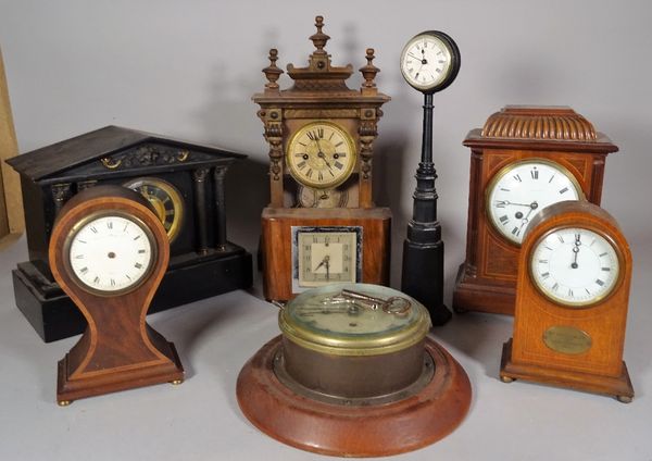 A group of eight early 20th century clocks, including; a porthole clock, 21cm wide, a clock formed as a lampost, 34cm high and six further clocks.  S1