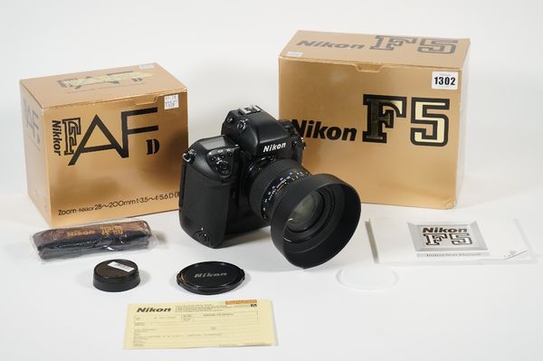 A Nikon F5 35mm camera body and a Nikkor 28-200mm F/3.5 zoom lens, both boxed.