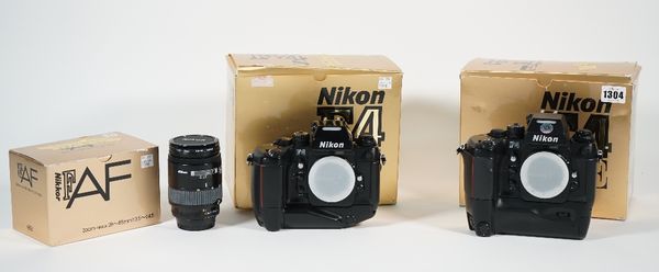 A Nikon F4E 35mm camera a Nikon F45 35mm camera and a Nikkor 28-85mm F/3.5-4.5n lens, all boxed, (3).