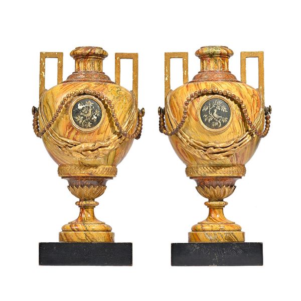 A pair of North European simulated marble and parcel gilt two handled vases, late 18th century / early 19th century, of urn form on an ebonised square