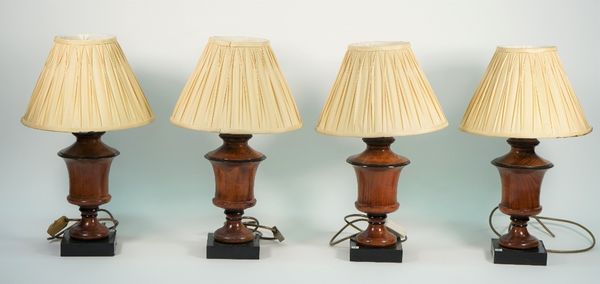 Four Victorian style wooden table lamps, each of turned urn form with cream pleated shades, 48cm high overall, (4).