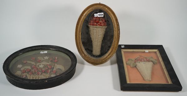 Three felt work pictures each depicting strawberries in a basket, two in deep oval frames, 35cm high, the third in an ebonised rectangular frame, 38cm