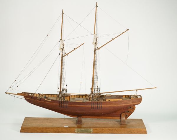 A scratch built wooden model ship 'Bluenose 1921' on an oak plinth, 59cm high and two decoupage pictures in Victorian burr maple frames, 31cm wide, (3