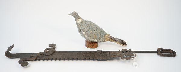 An early 20th century painted tin decoy pigeon on a wooden plinth, 35cm, another papier mache bound wire work decoy pigeon, 40cm and an 18th century w