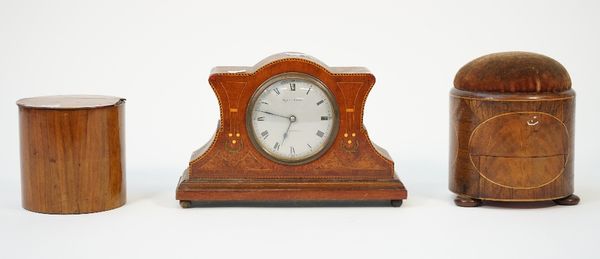 A 19th century mahogany and inlaid pin cushion of circular form with a frieze drawer and three bun feet, 15cm high, a 19th century yew wood circular t