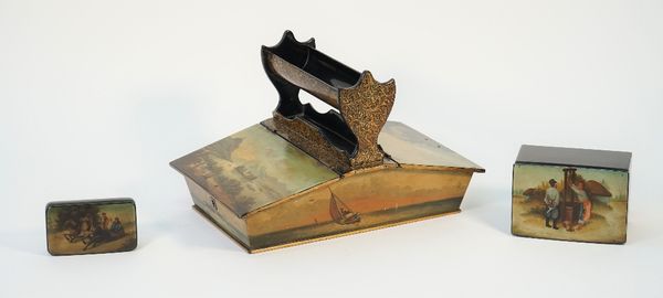 A Victorian black gilt and painted papier mâché stationery stand by Jenners & Betteridge, mid-19th century, with a central raised pen tray, flanked by