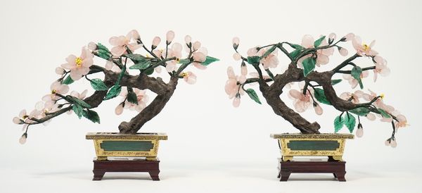 A pair of Chinese hardstone floral bonsai each in a gilt metal rectangular pot on a hardwood stand, 19cm high, (2).