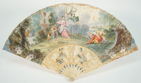 A Continental painted paper fan, late 18th century, detailed with figures in a garden against painted and pierced, carved ivory sticks, 29cm.