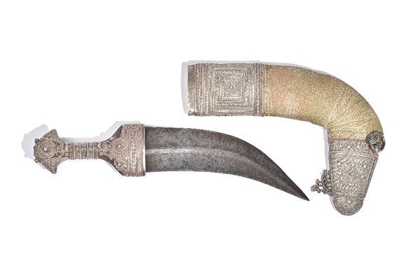 An Arabian Jambiya knife, 19th century, with double edged curved steel blade, 19cm and ornate white metal mounts to the handle and sheath, knife 31.5c