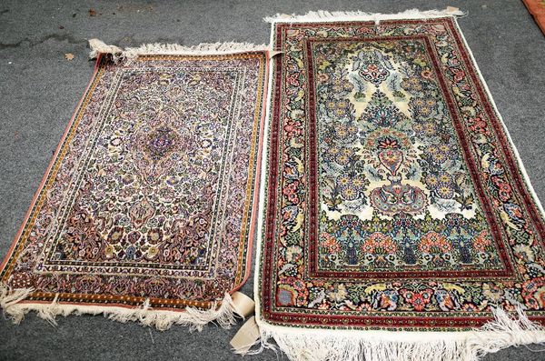 An Indian part silk rug, the ivory field with pink medallion, 120cm x 79cm and an Indian part silk prayer rug, the ivory field with a vase and abundan