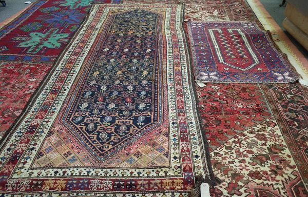 A Turkish prayer rug, madder mehrab with two plants, an indigo leaf border, 140cm x 93cm and a North West Persian kelleh, the black field with an trel