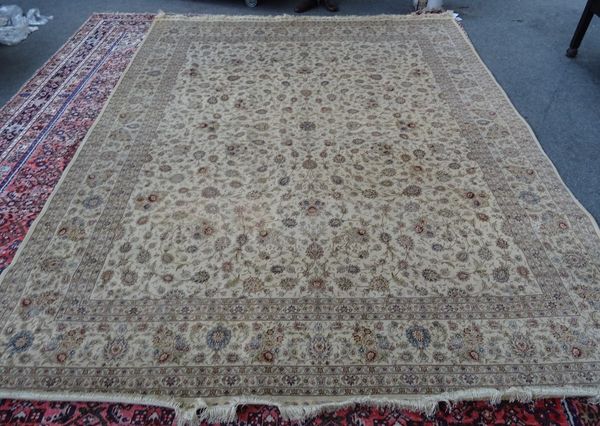 A Hereke silk carpet, Turkish, the ivory field with a delicate allover floral vine design, a complementary palmette and vine border, 313cm x 247cm.