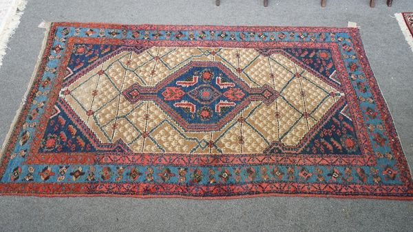 A Hamadan rug, Persian, the fawn trellis field with an indigo medallion, matching spandrels; a pale indigo flower border, 203cm x 118cm.