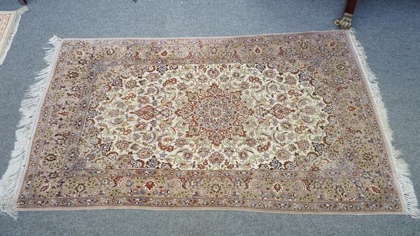 A fine part silk Esfahan rug, Persian, the ivory field with a brown shaped medallion, matching spandrels, all with intricate floral sprays, a brown pa