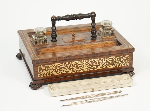 T. DALTON LONDON; a William IV brass inlaid rosewood desk tidy with twin inkwells and pen tray over frieze drawers, on melon carved feet, 31cm wide x