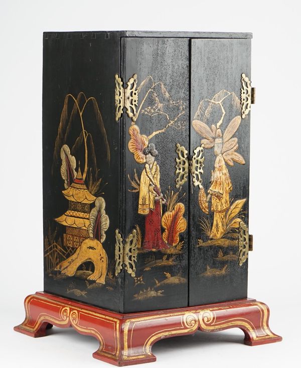 An Eastern lacquered two door table cabinet on parcel gilt bracket feet, 34cm wide x 53cm high.