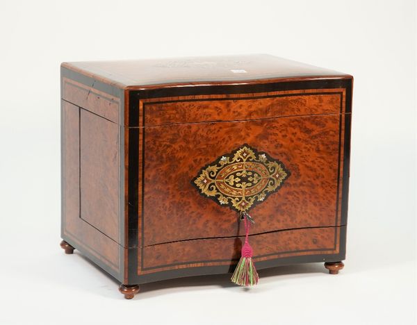 A 19th century brass and mother of pearl inlaid liqueur cabinet, the serpentine lift top and front revealing a four decanter interior, 32cm wide x 28c