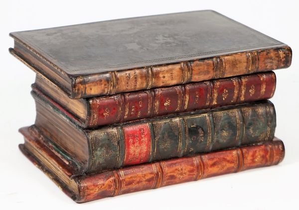 A tea caddy formed as a stack of leather bound books, 19cm wide x 10cm high.