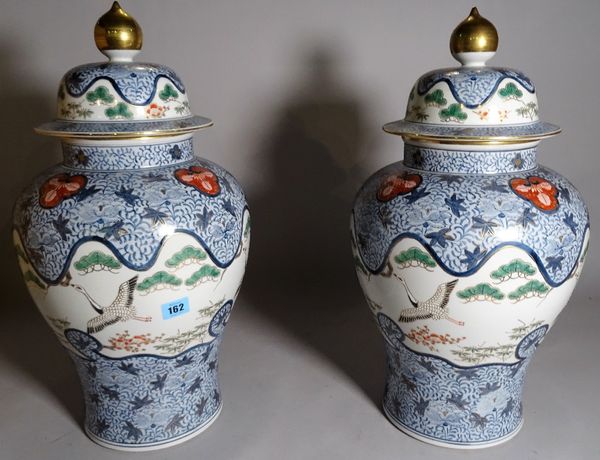 A pair of modern Chinese style porcelain vases and covers, foliate Imari decorated against a baluster ground, 52cm high, (2). D5