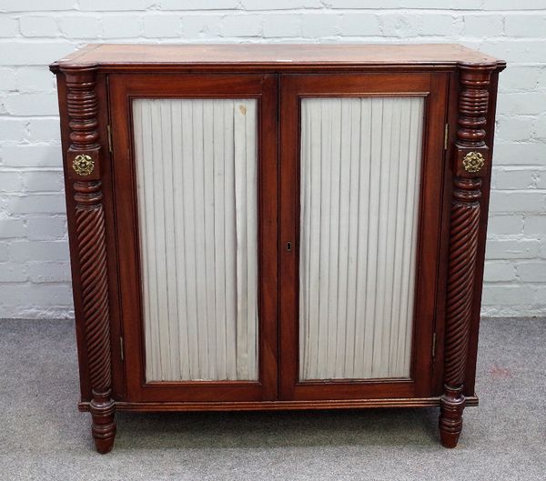 An early 19th century brass inlaid mahogany side cabinet, with pair of doors flanked by spiral fluted columns, 94cm wide x 91cm high x 42cm deep.