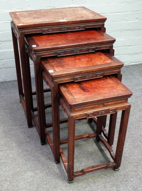 A nest of four Chinese hardwood and burrwood occasional tables, with carved frieze, on block supports, the larger 50cm wide x 64cm high, (4).