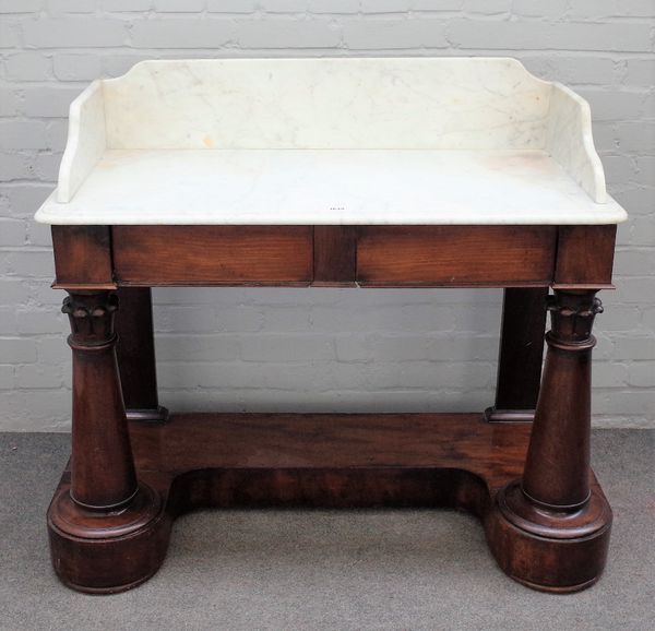 A Victorian wash stand, the marble top over a mahogany two drawer base on turned columns united by platform, 108cm wdie x 98cm high.