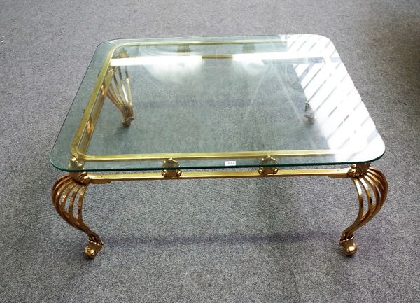 A 20th century coffee table, the rounded square glass top on four lacquered brass open slatted supports, 107cm wide x 45cm high.