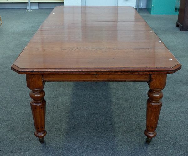 A Victorian inlaid oak extending dining table, the canted rectangular top on tapering octagonal supports, with three extra leaves, 120cm wide x 117cm