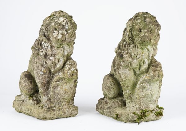 A pair of reconstituted stone figures of sergeant lions holding a shield, 16cm wide x 38cm high, (2).