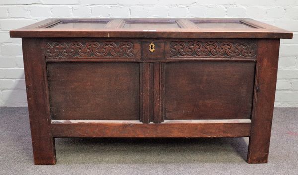 A 17th century oak coffer with triple panel lid and double panel front on stile feet, 114cm wide x 61cm high.