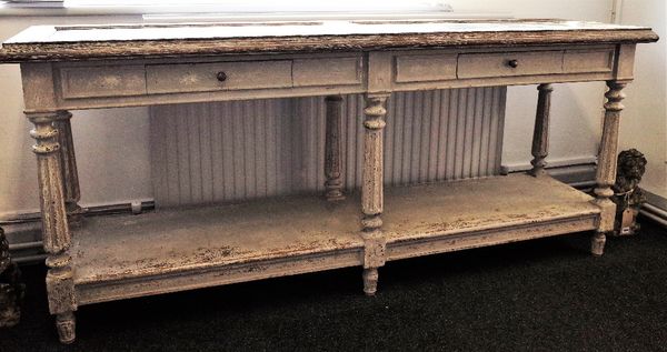 A painted serving table, the double marble inset top over a pair of frieze drawers, on fluted supports, united by platform undertier, 200cm wide x 86c