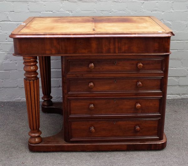 A Victorian mahogany flat topped Davenport, the hinged leather inset top over four side drawers, and dummy verso, resting on reeded supports, 61cm wid