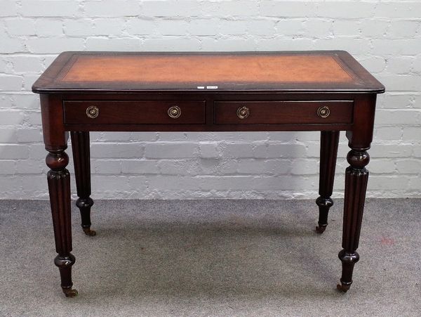 A mid-19th century mahogany writing table, with pair of frieze drawers, on reeded supports, 106cm wide x 76cm high.