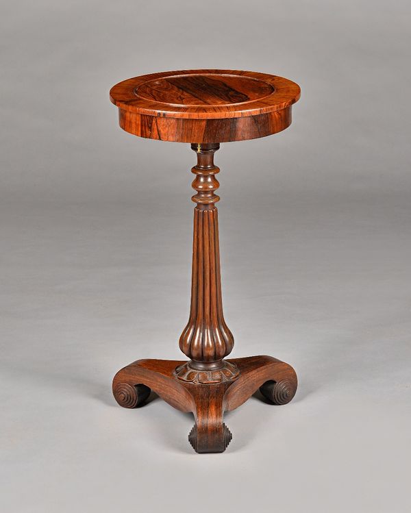 A Regency rosewood jardiniere, the circular top with pop-out centre, on reeded column and three scroll supports, 38cm diameter x 69cm long. Illustrate