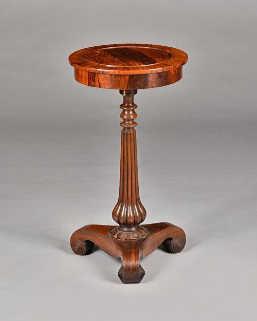A Regency rosewood jardiniere, the circular top with pop-out centre, on reeded column and three scroll supports, 38cm diameter x 69cm long. Illustrate