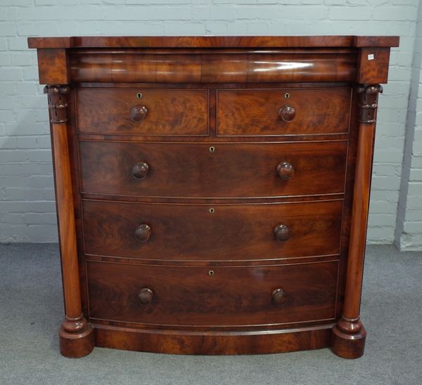 An early Victorian mahogany bowfront chest, with cushion frieze drawer, over two short and three long graduated drawers, flanked by turned columns, 12