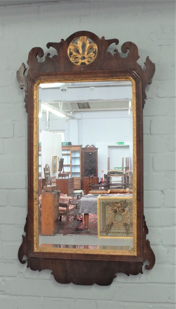 A large 18th century parcel gilt walnut fret cut pier glass, 62cm wide x 110cm high.